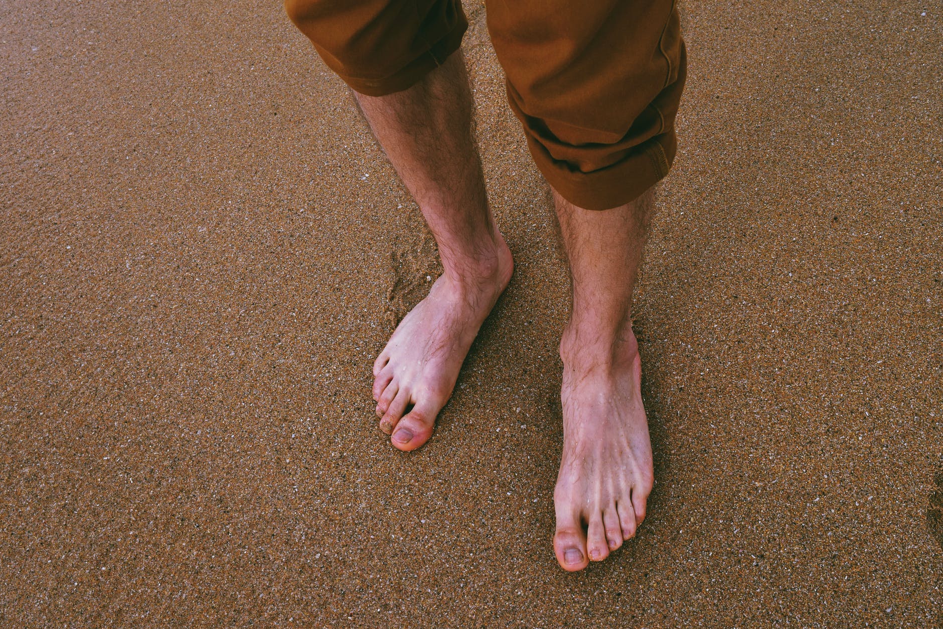 close up photo of person standing on seashore
