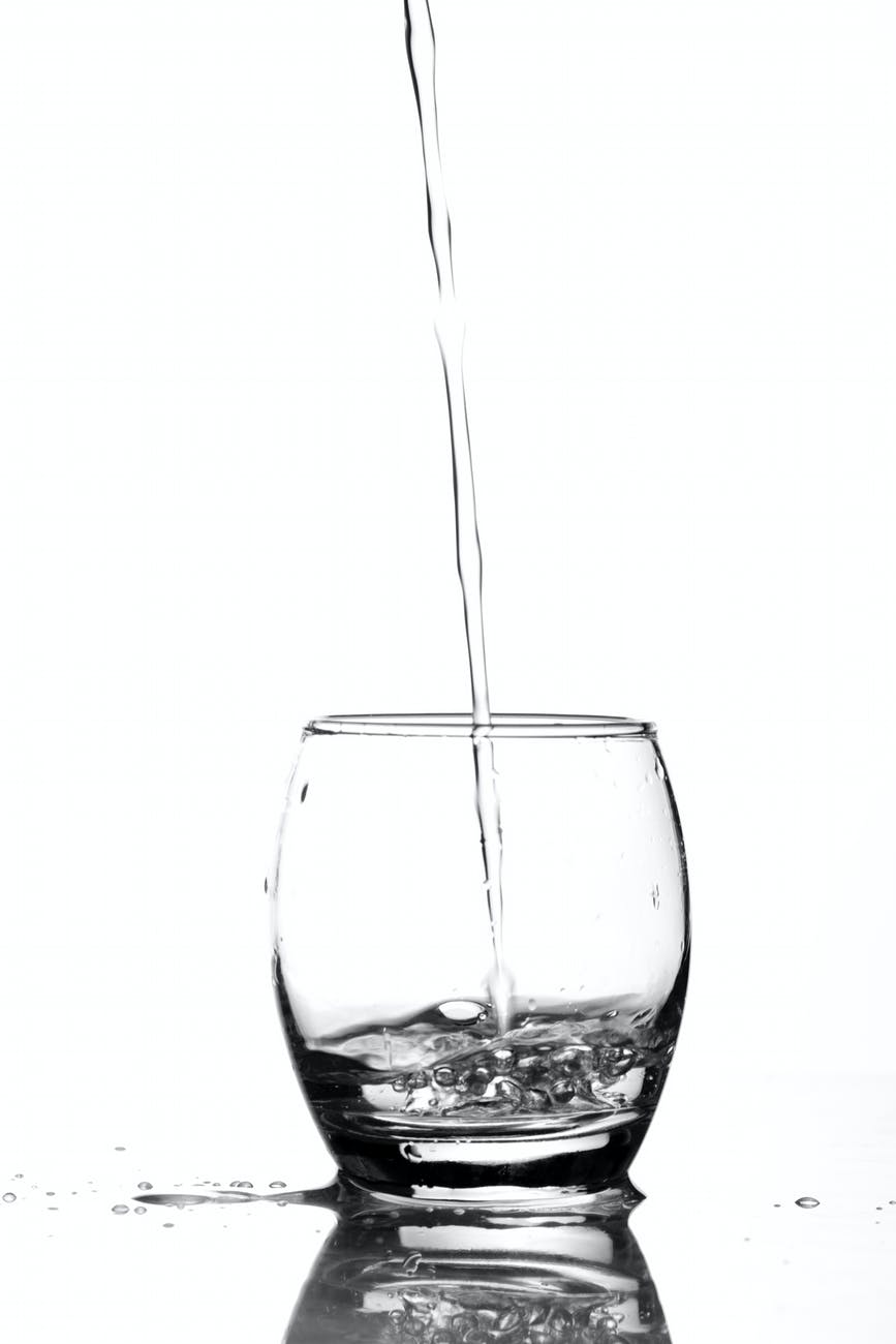 close up of water pouring in glass
