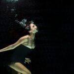 woman wearing black dress under water photography