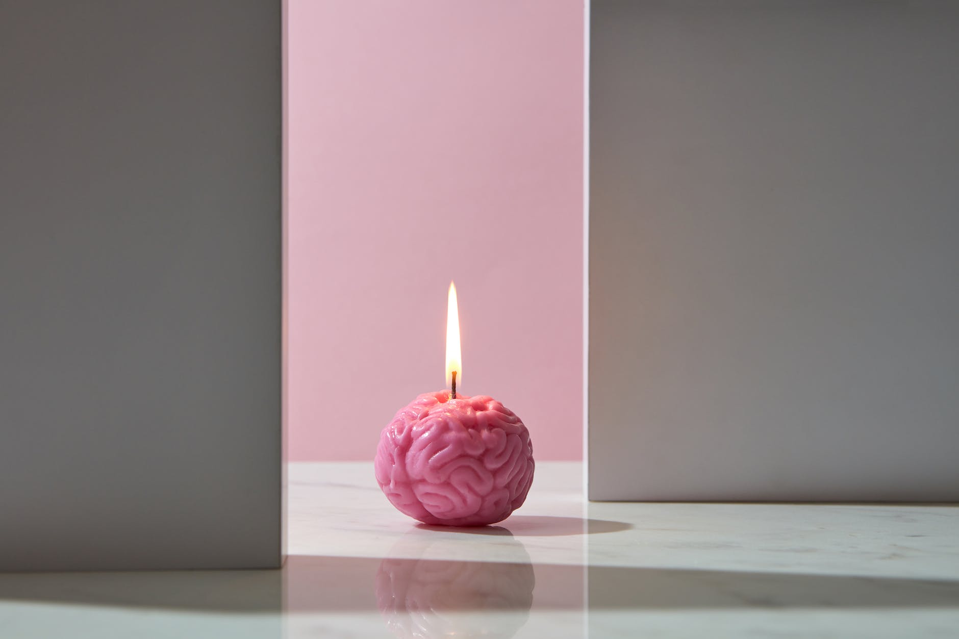 photograph of a lit brain candle