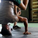 man putting his head on gorund