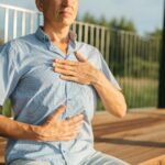 person s hands on his chest